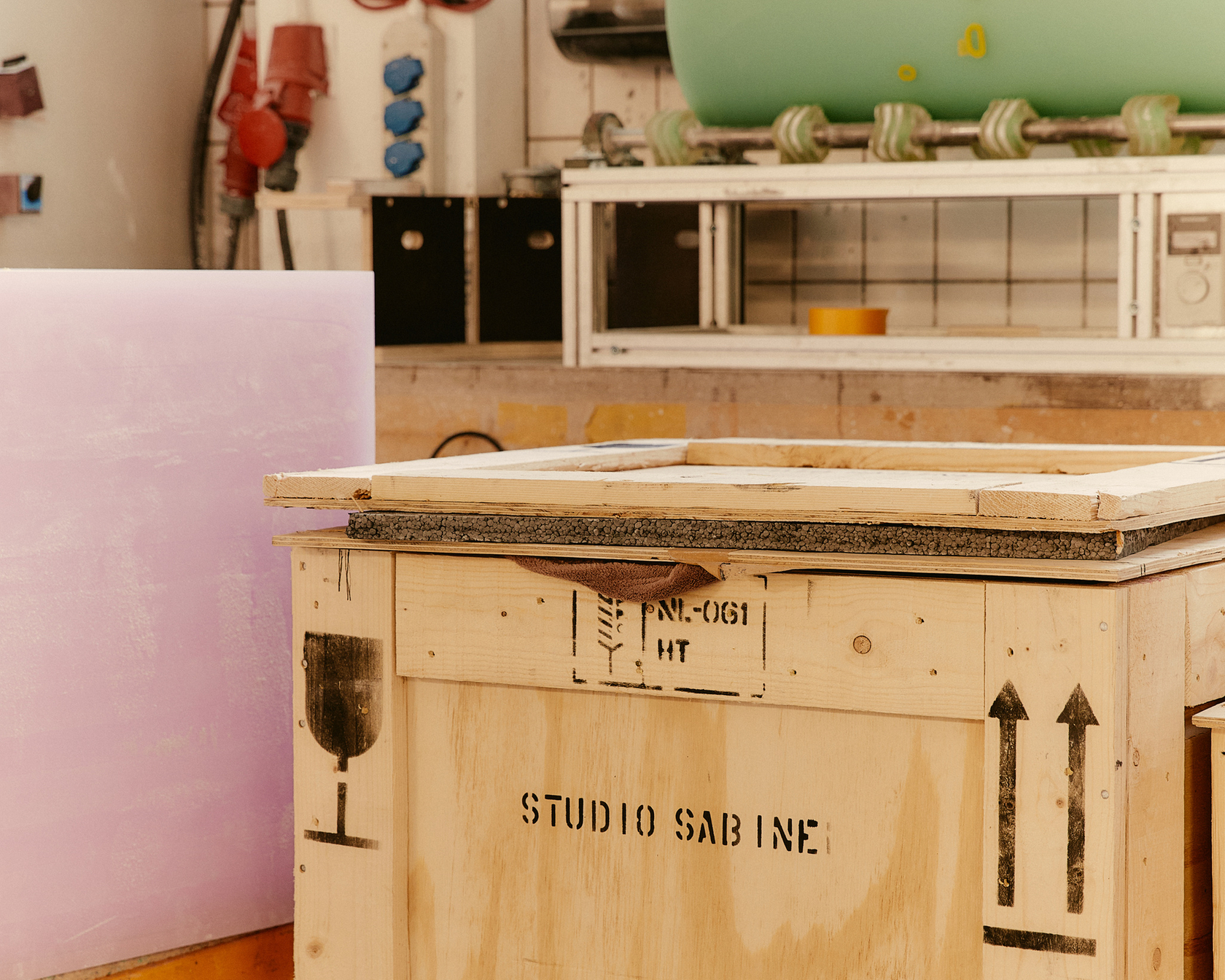 Wooden box in a workshop with tools and industrial environment.