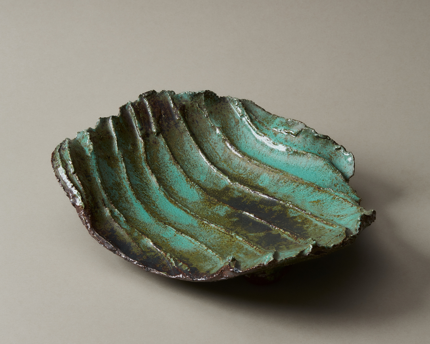 Handmade ceramic bowl with green glaze and rustic design