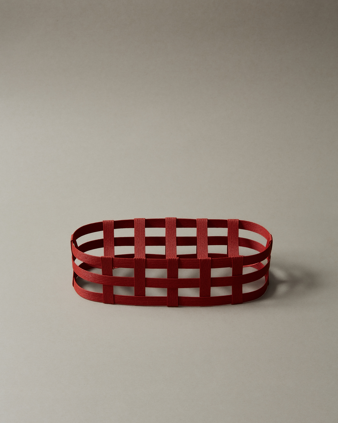Red minimalist basket on a neutral background