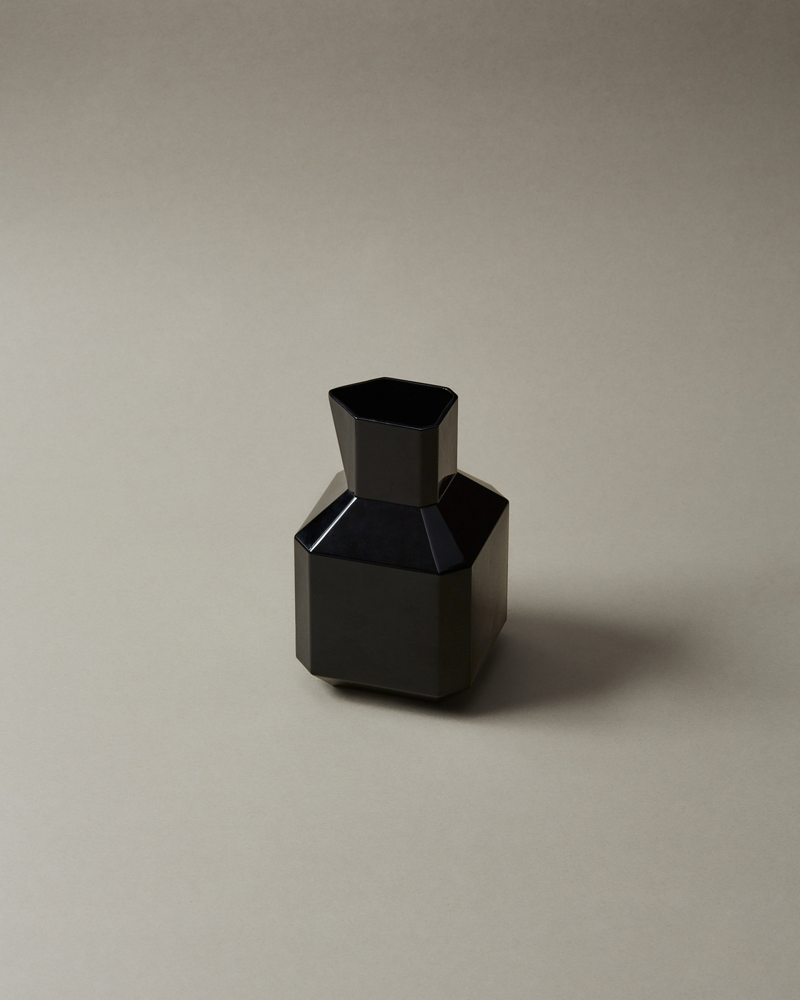 Black geometric vase on a neutral background
