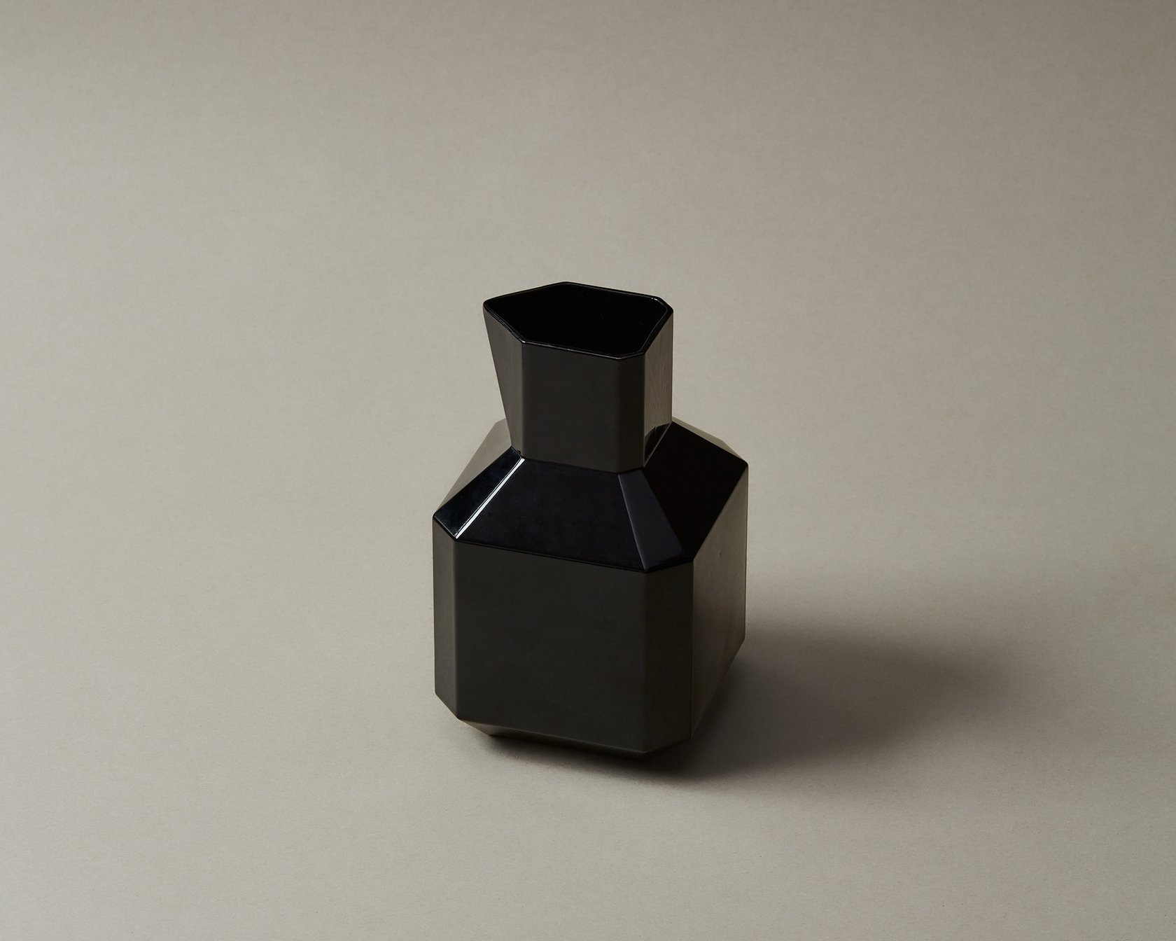 Black geometric vase on a neutral background