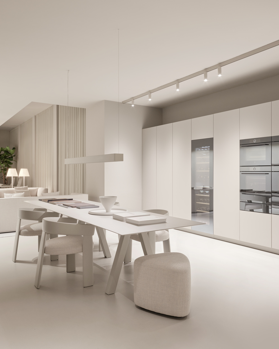 Modern kitchen with built-in appliances such as ovens and wine cabinet in a minimalist design
