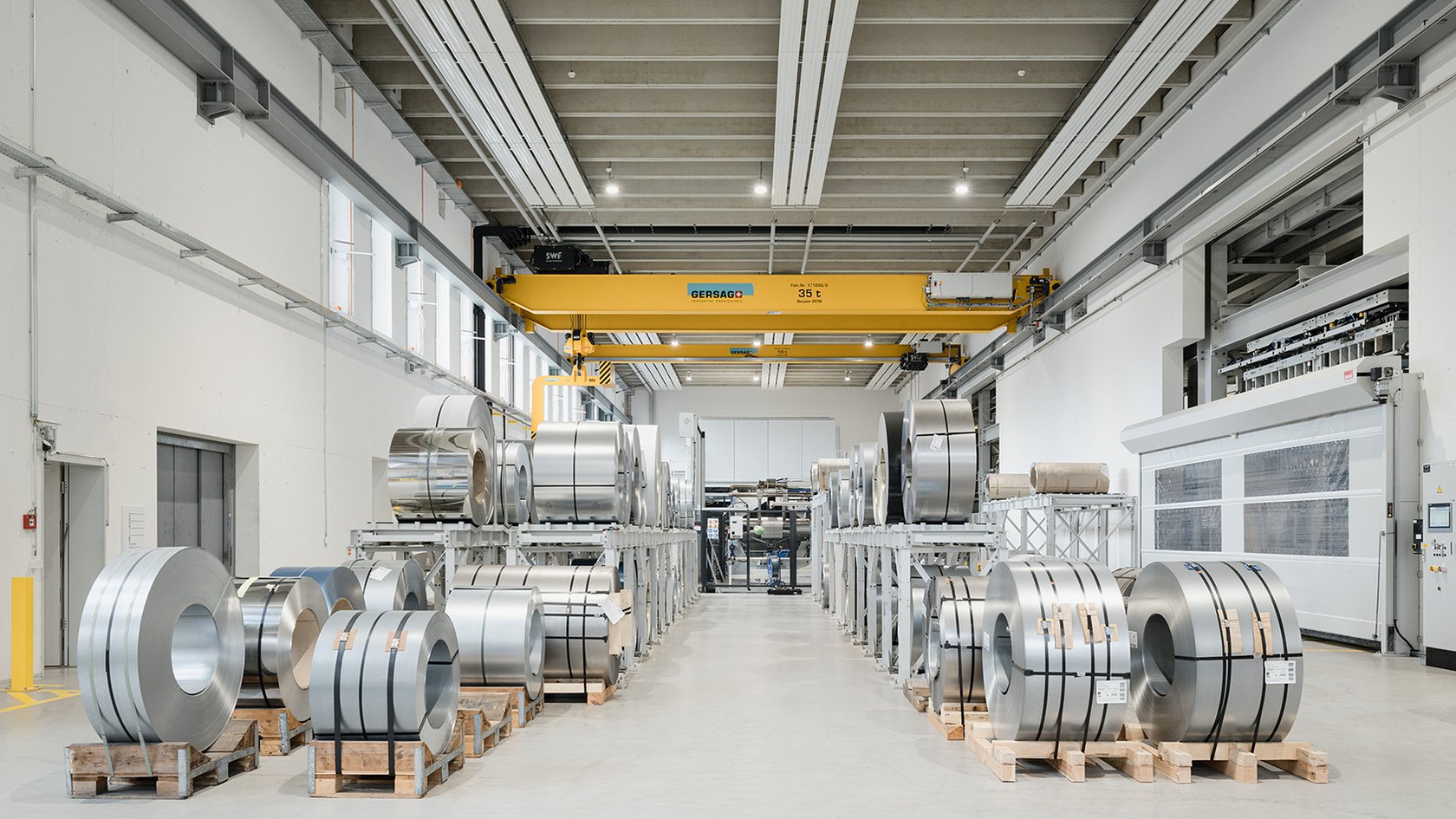 Steel coils in a modern warehouse with an industrial design and efficient organization.