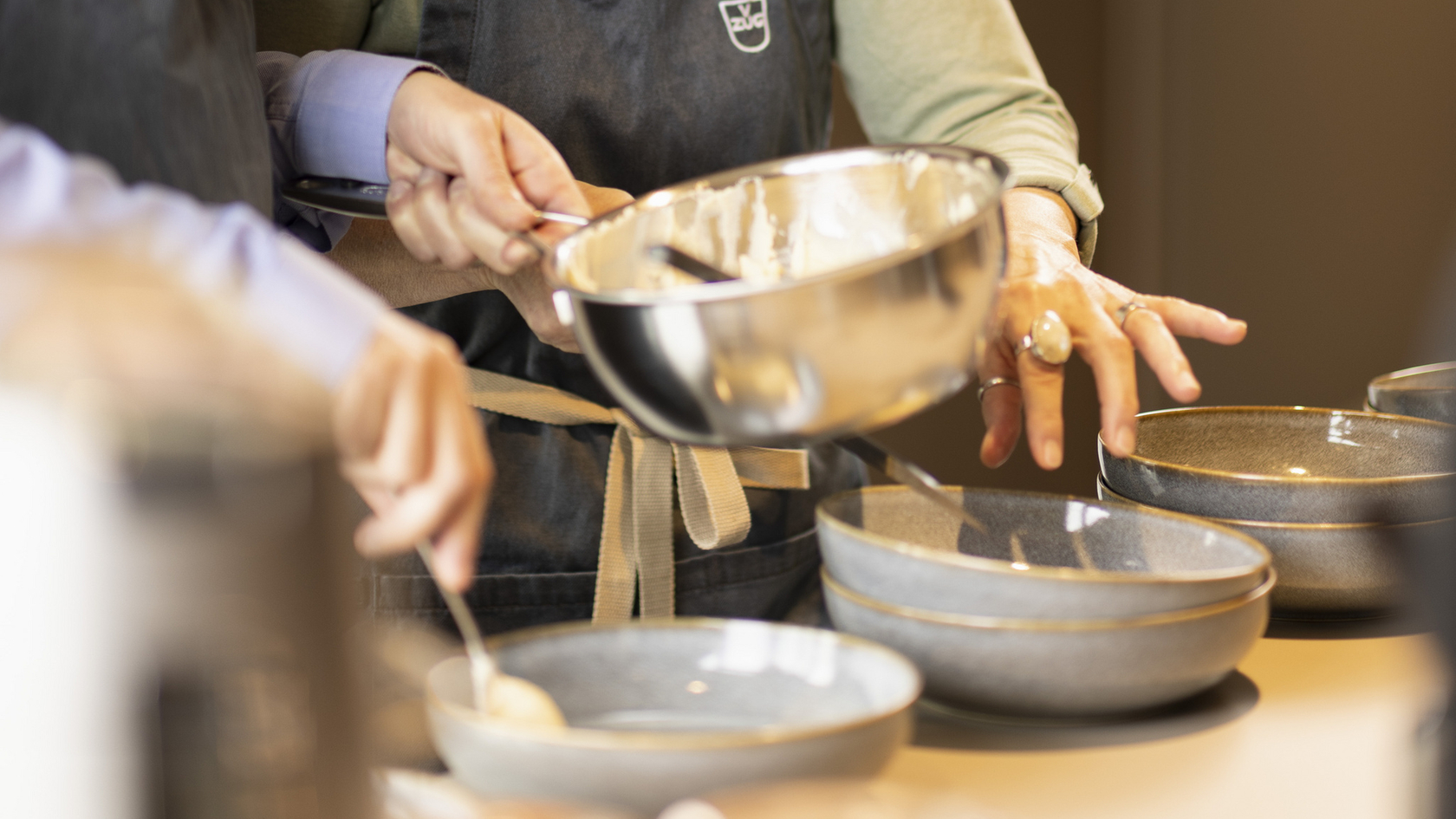 Preparation of a dish in a modern kitchen with batter bowl and bowls.