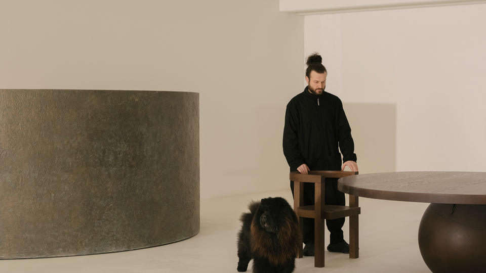 Black dog in a minimalist room with modern design and furniture.