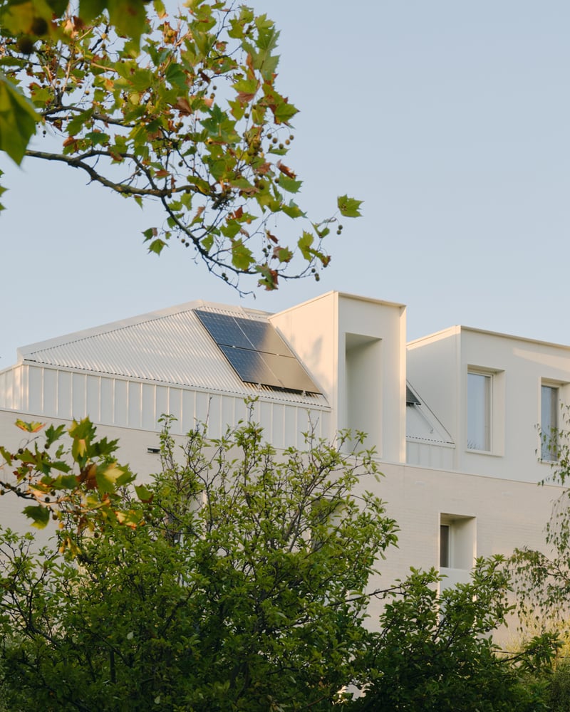 Modern house with solar panels and green surroundings