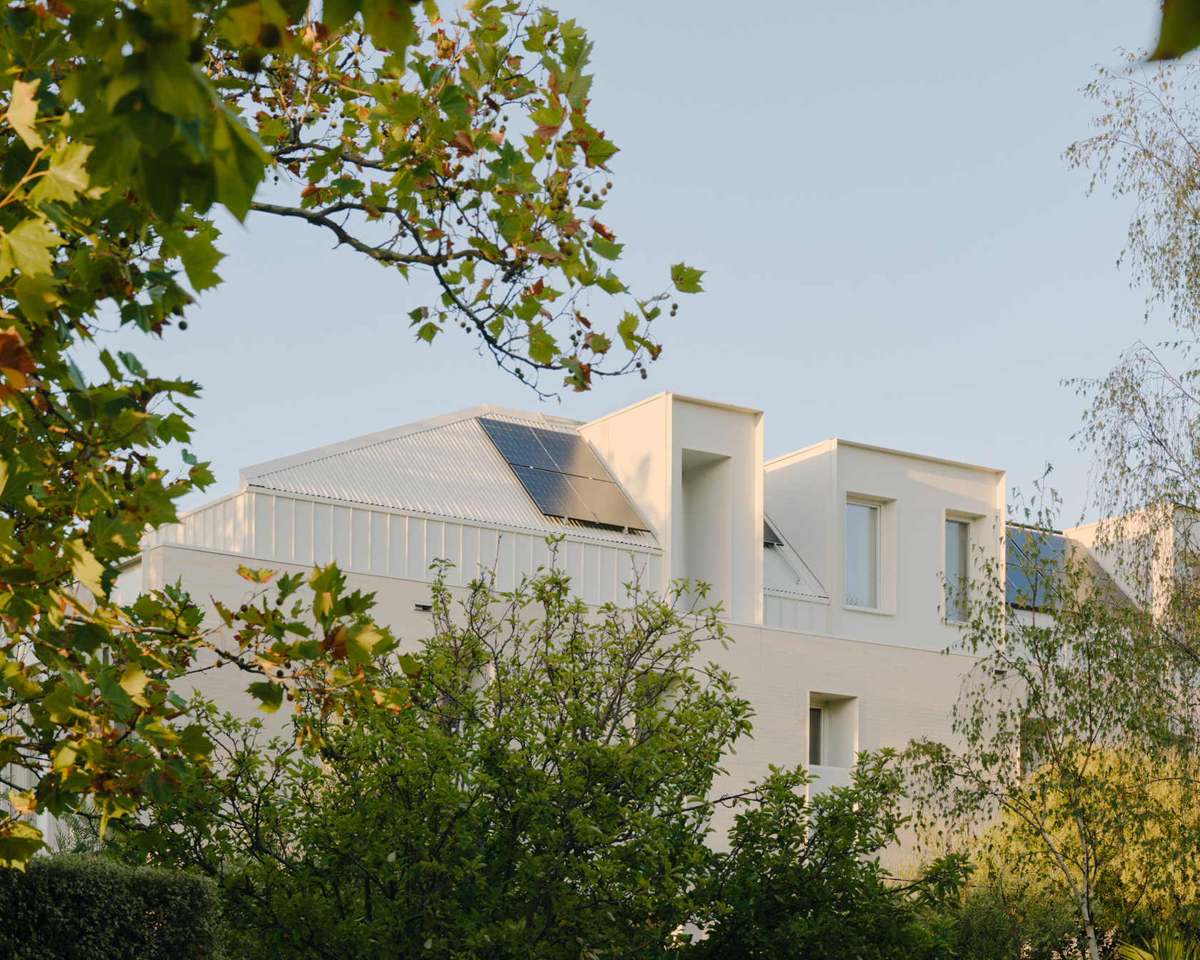 Modern house with solar panels and green surroundings