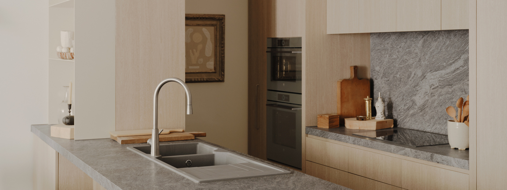 Modern kitchen with stone worktop and built-in appliances