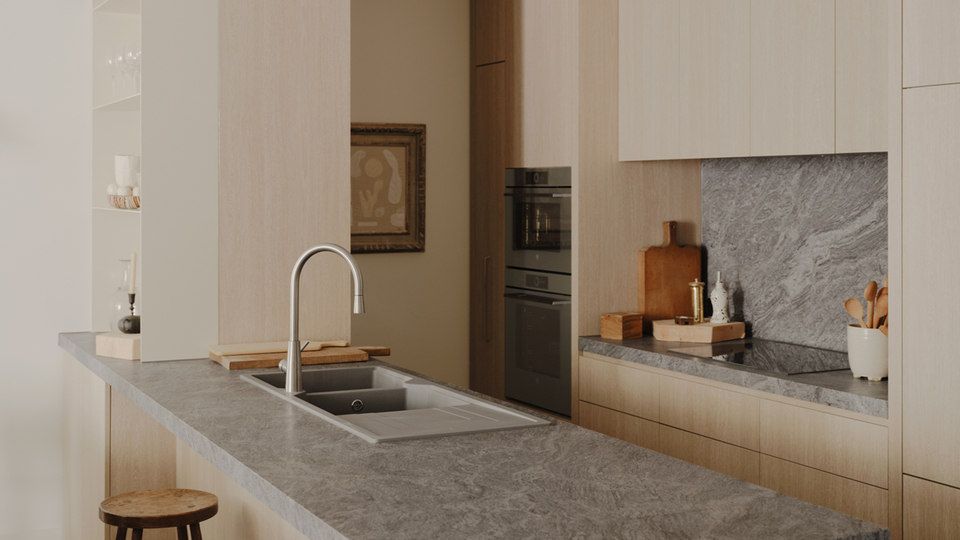 Modern kitchen with stone worktop and built-in appliances