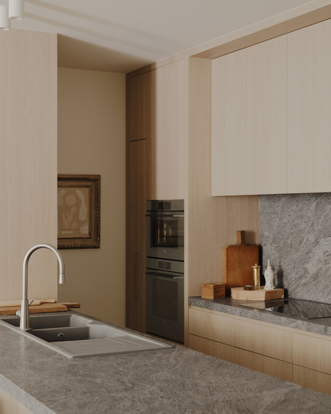 Modern kitchen with stone worktop and built-in appliances