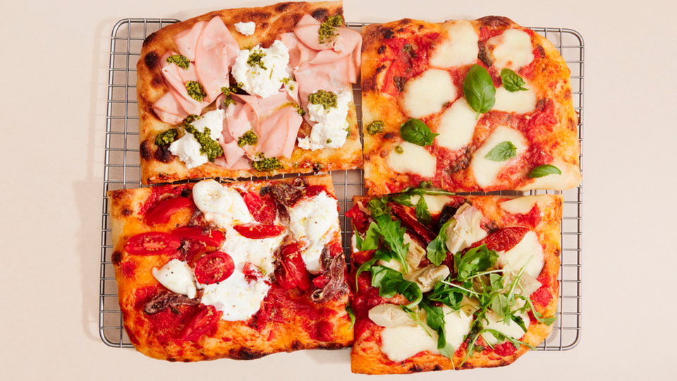 Pizza variations with fresh ingredients such as mozzarella, tomatoes and basil arranged on a grid.