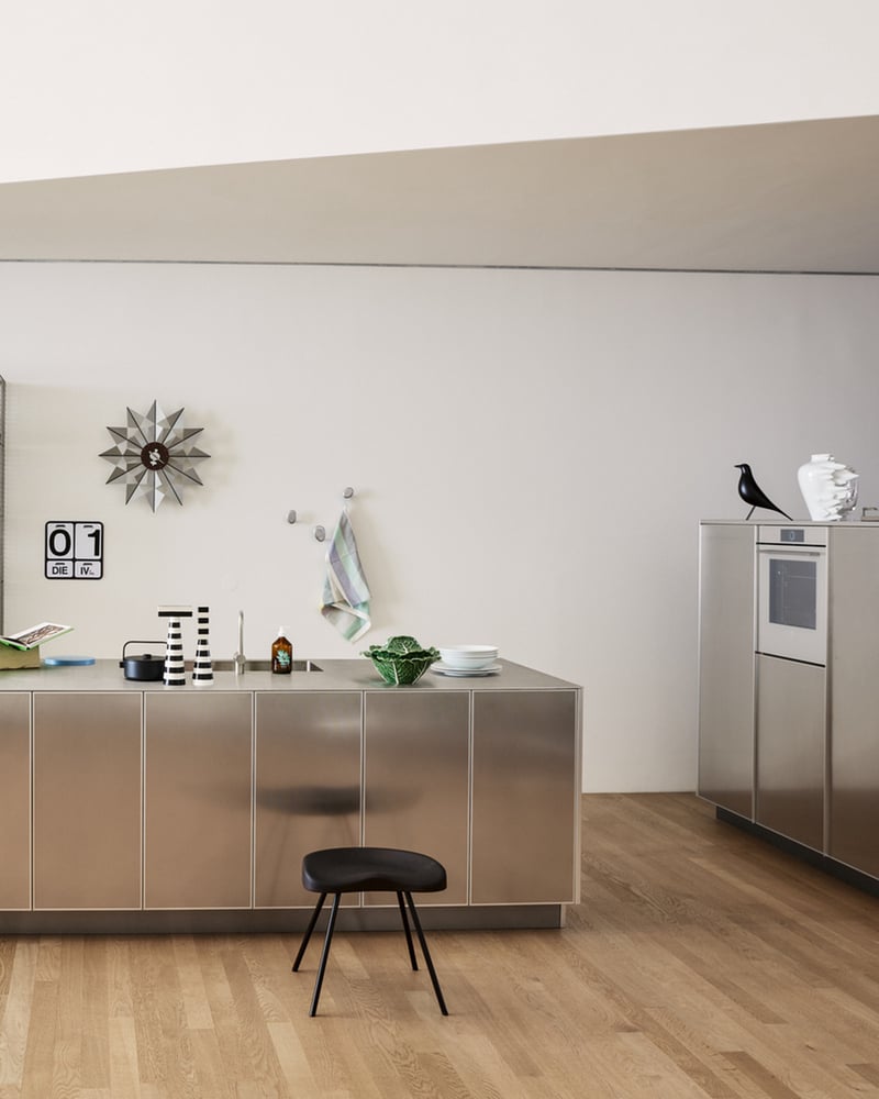Modern kitchen with stainless steel island and minimalist furnishings