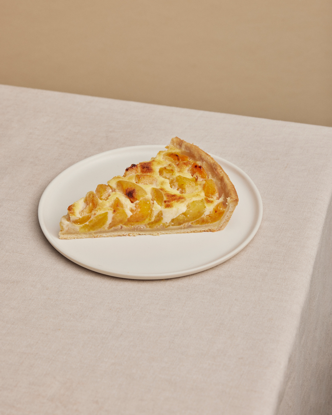 A slice of fruit cake on a plate, perfect for a cozy coffee break.