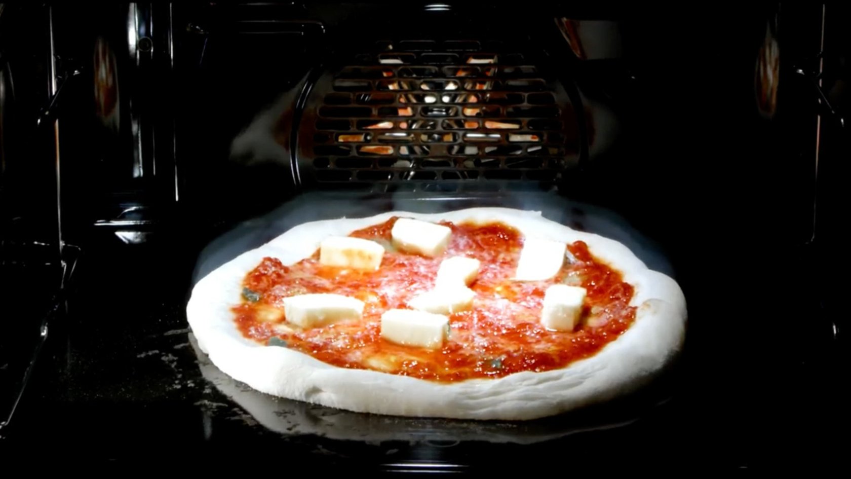 Pizza Margherita in the oven during the baking process