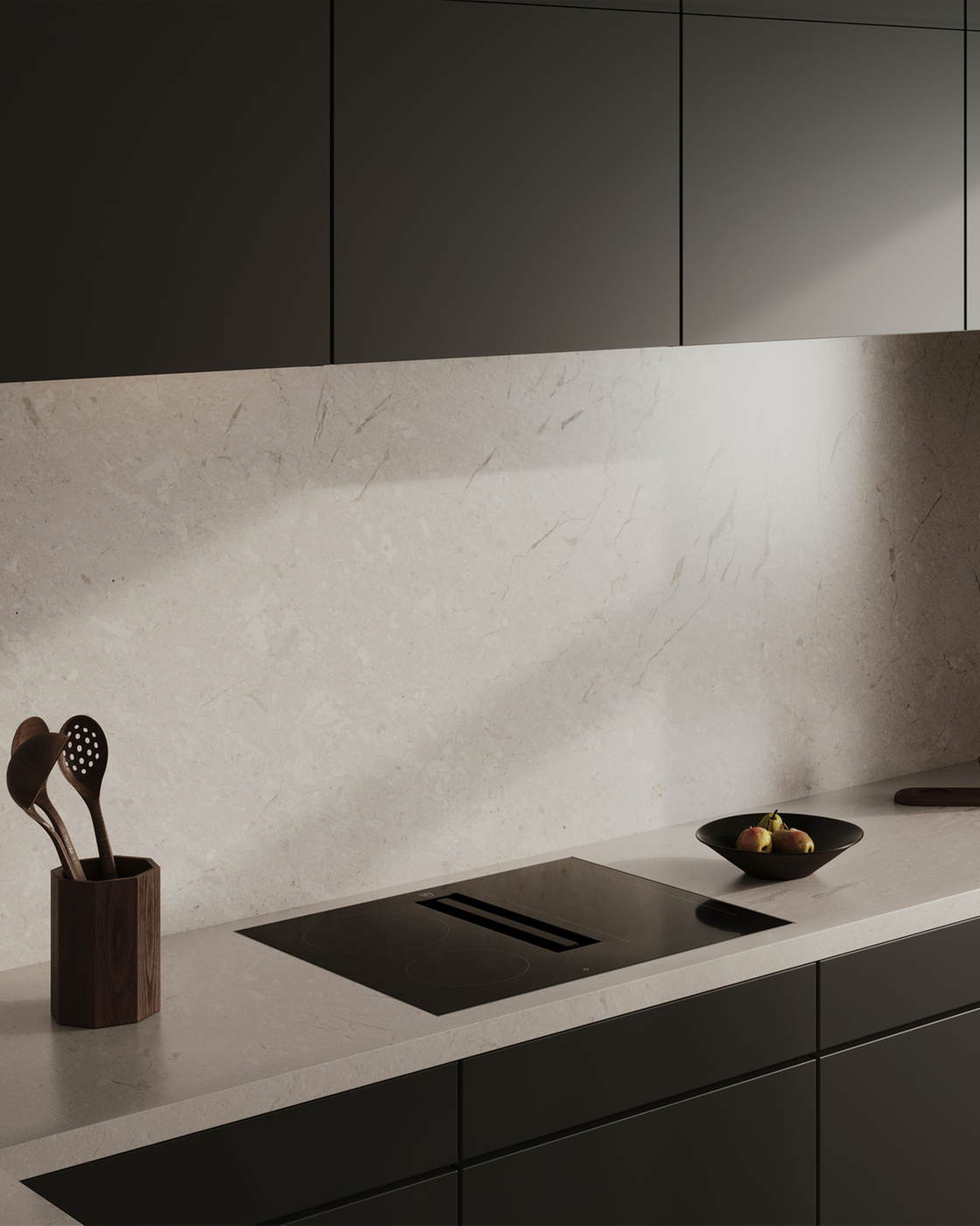 Cuisine moderne avec des armoires sombres et une table de cuisson intégrée