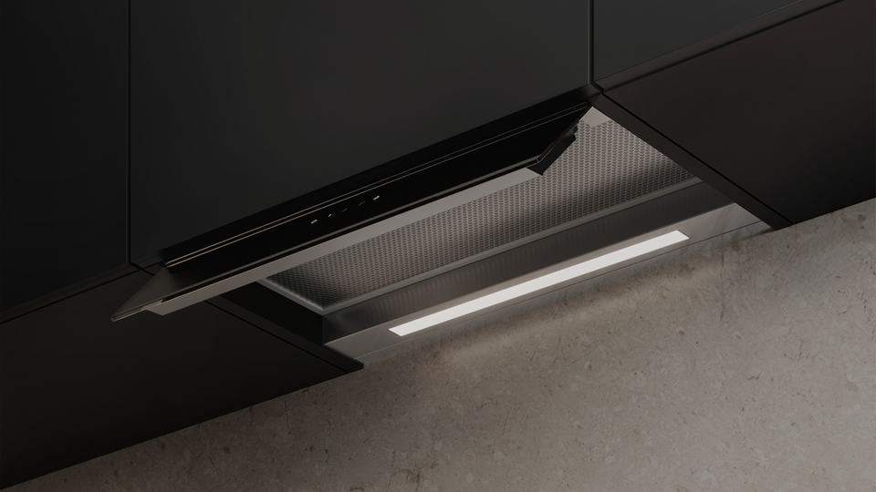 Aspiratore nero in una cucina moderna con mobili scuri e parete in pietra chiara