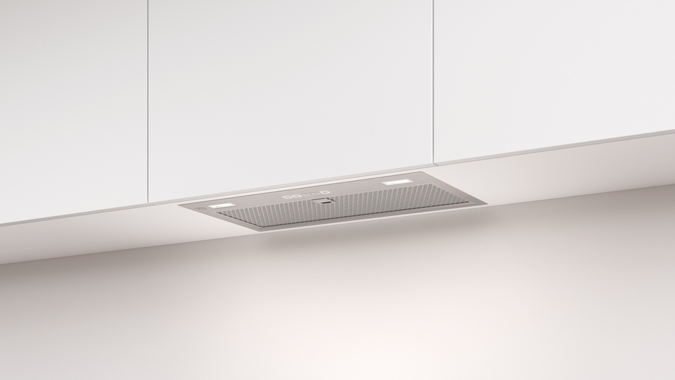 Modern under-counter extractor fan in a minimalist kitchen