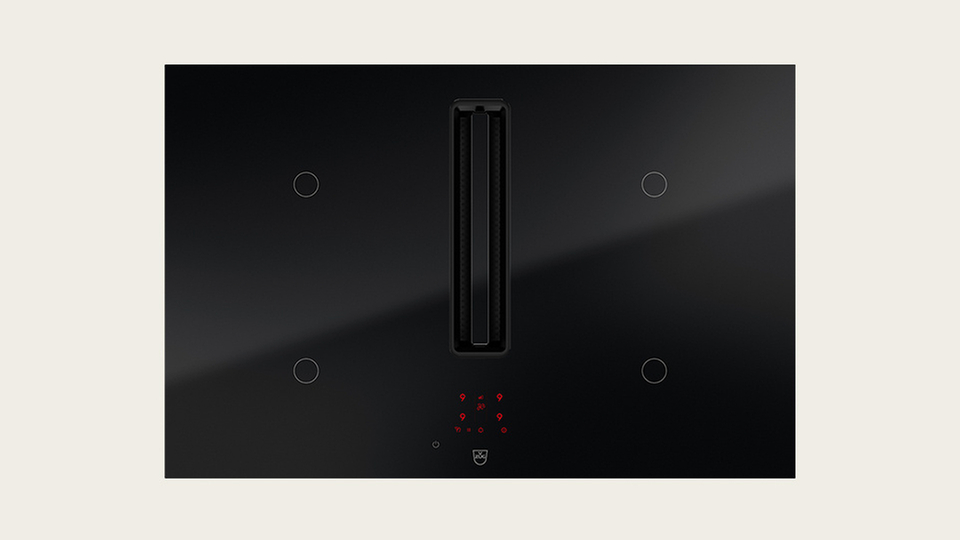 Black cooktop with integrated extractor fan and touch controls for the kitchen.