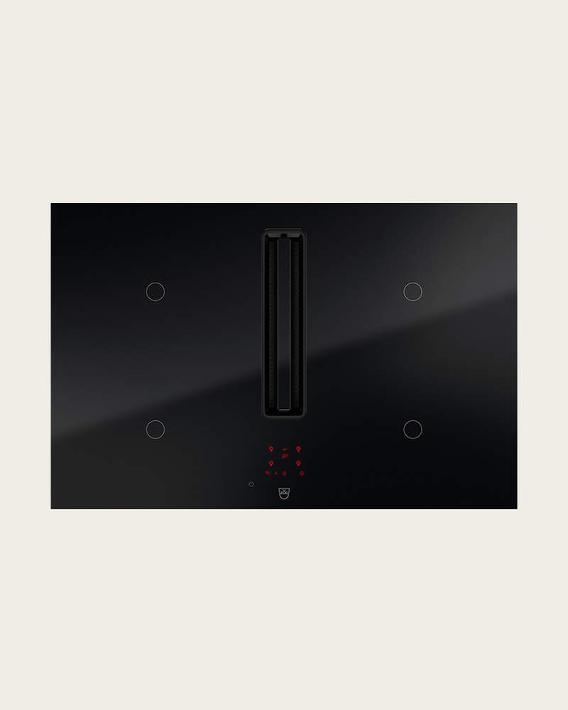 Table de cuisson noire avec hotte aspirante intégrée et commande tactile pour la cuisine.