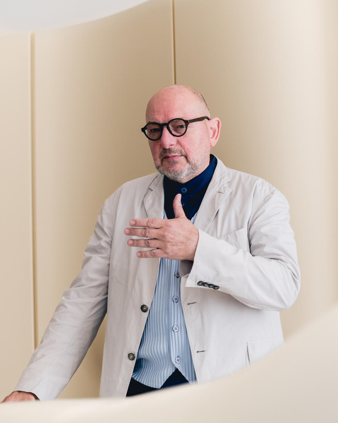 Person in professional clothing in front of a minimalist background