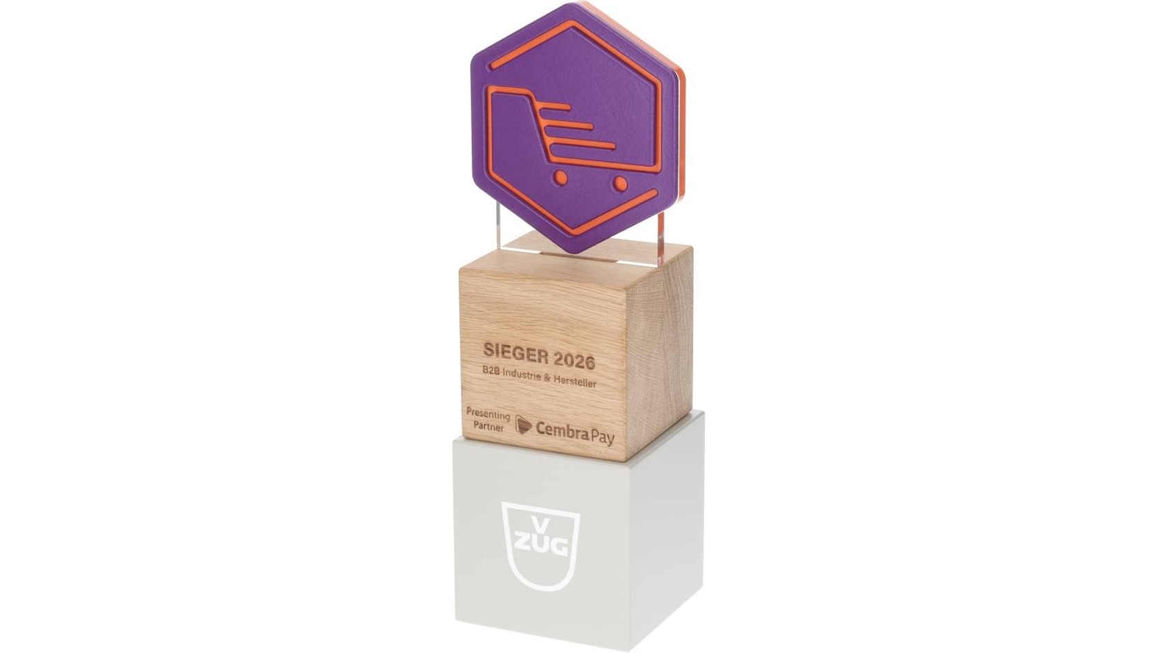 Prix « Vainqueur 2026 » décerné par V-ZUG, présenté sur un socle en bois et en acrylique.