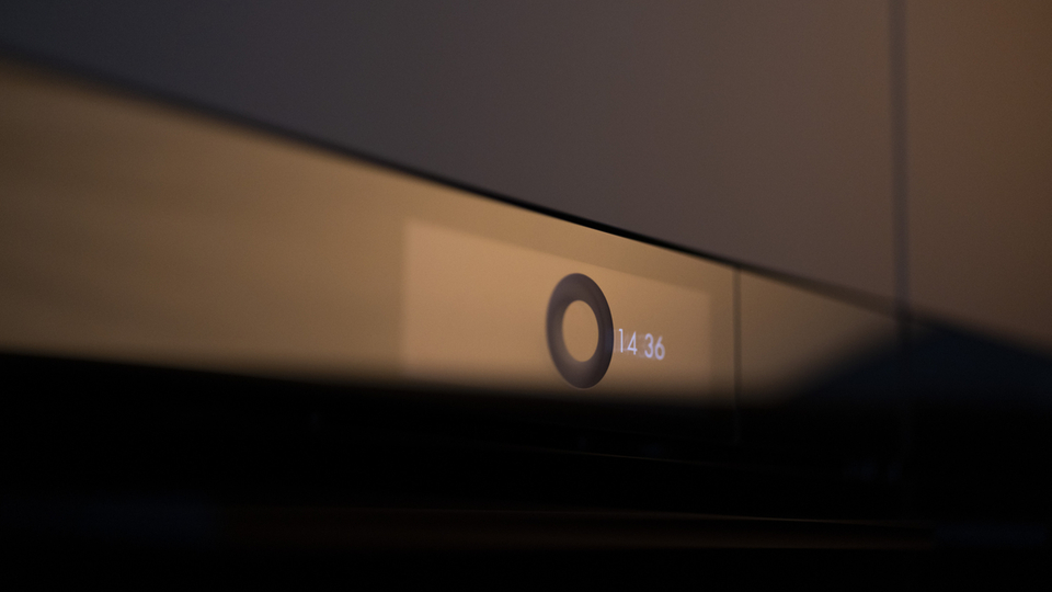 Close-up of an illuminated oven display in a modern kitchen.