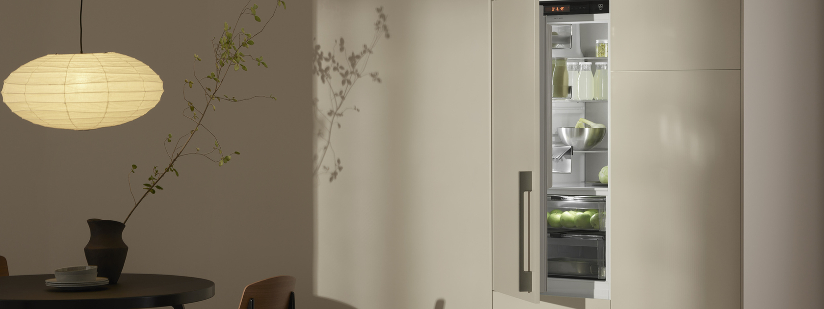 Modern refrigerator in an elegant kitchen with minimalist lighting and stylish design.