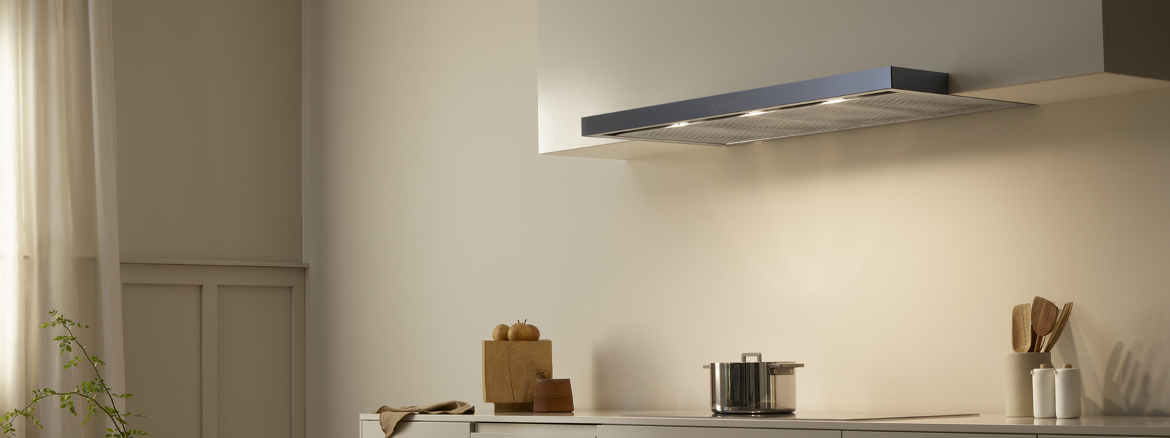 Modern kitchen with extractor fan above a hob in a minimalist design