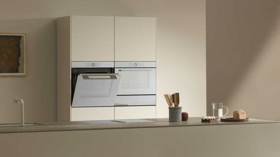 Modern kitchen with two built-in ovens and minimalist furnishings.