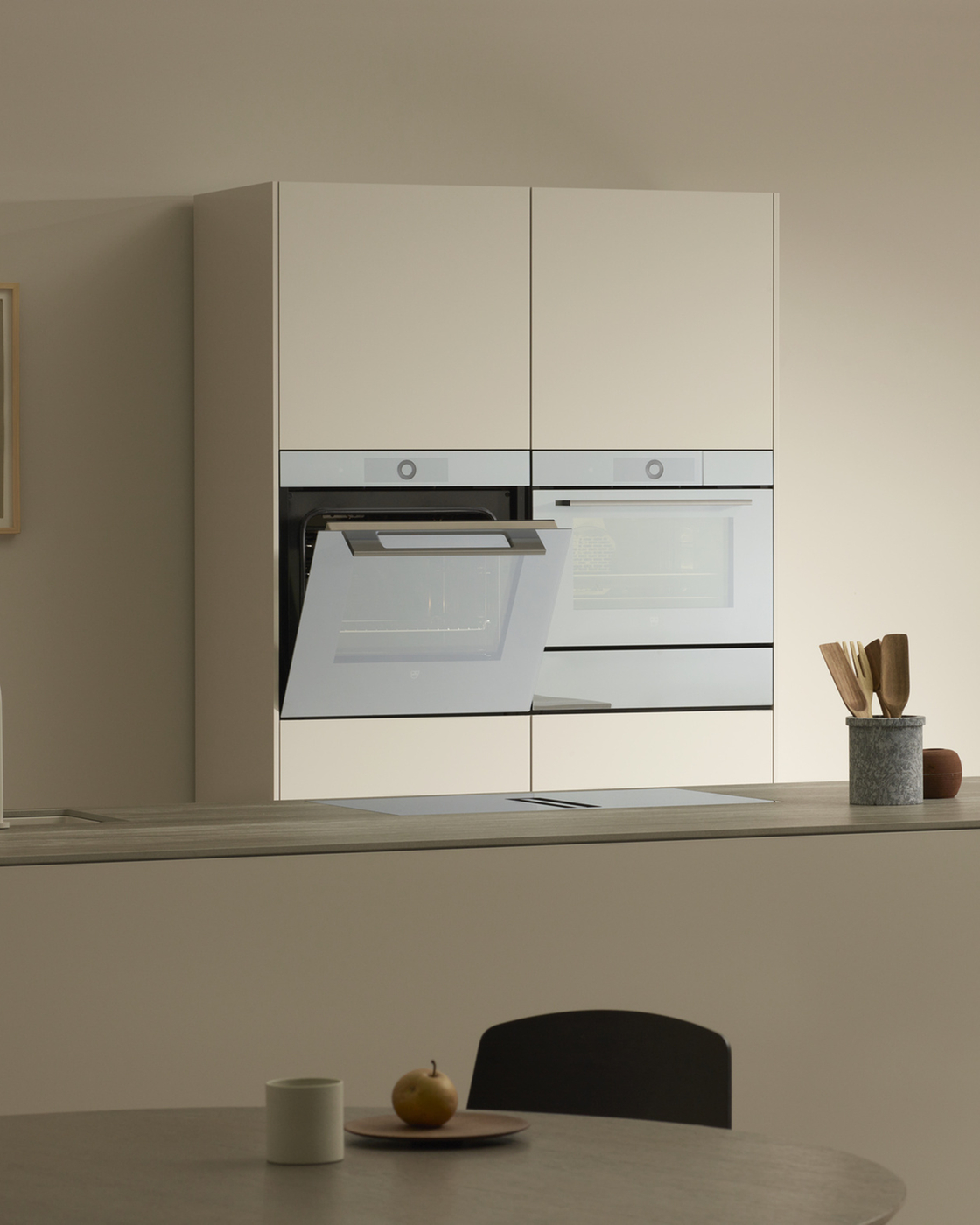 Modern kitchen with two built-in ovens and minimalist furnishings.