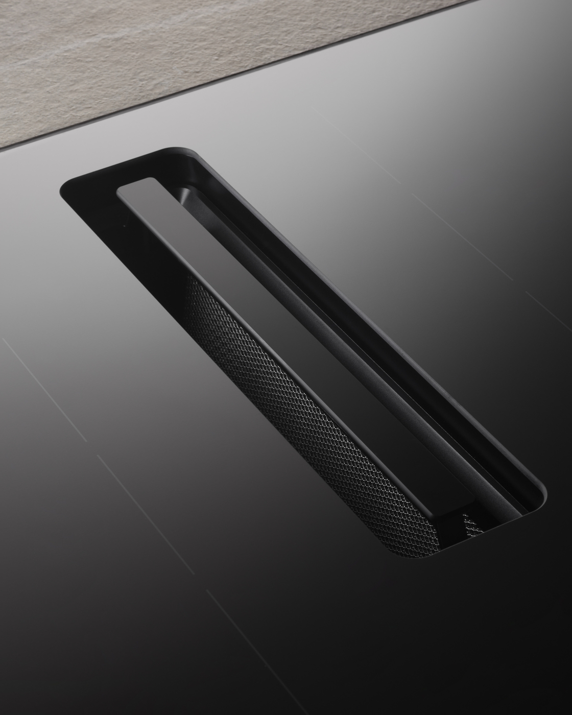 Cooktop with integrated extractor fan in black design for modern kitchens.